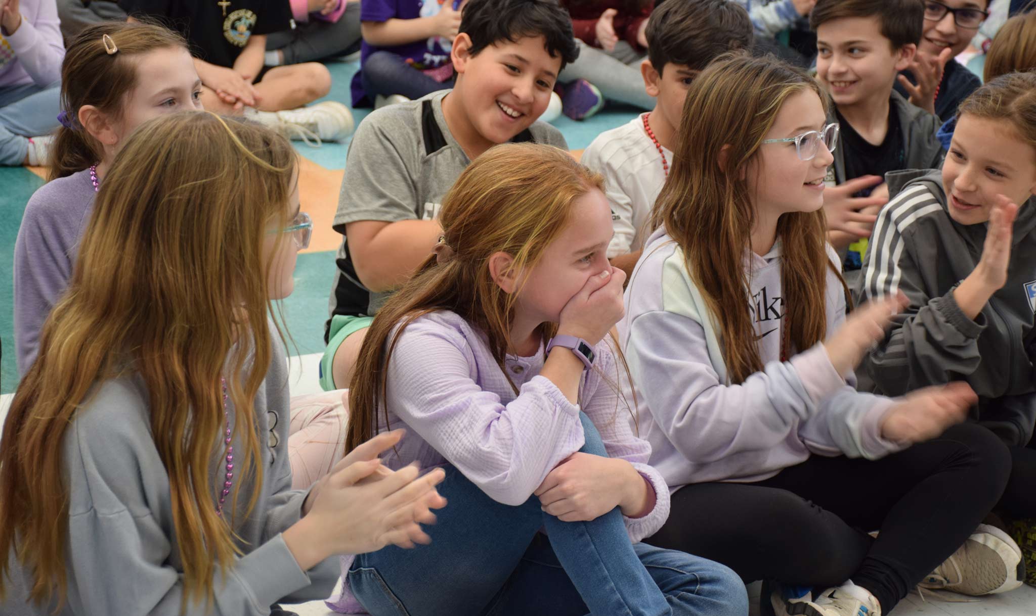 Grace (center) learned that she won at a school assembly!