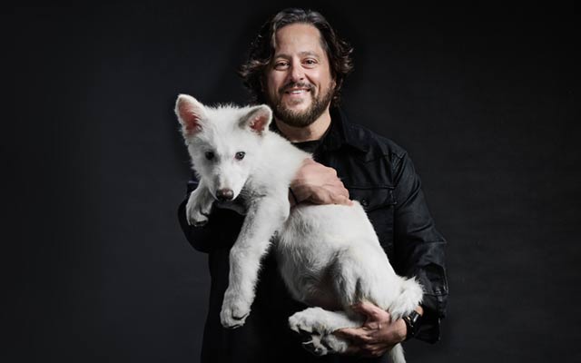 Colossal founder Ben Lamm holds a dire wolf pup.