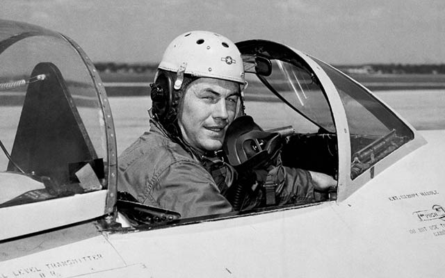 Pilot Chuck Yeager poses in a jet’s cockpit