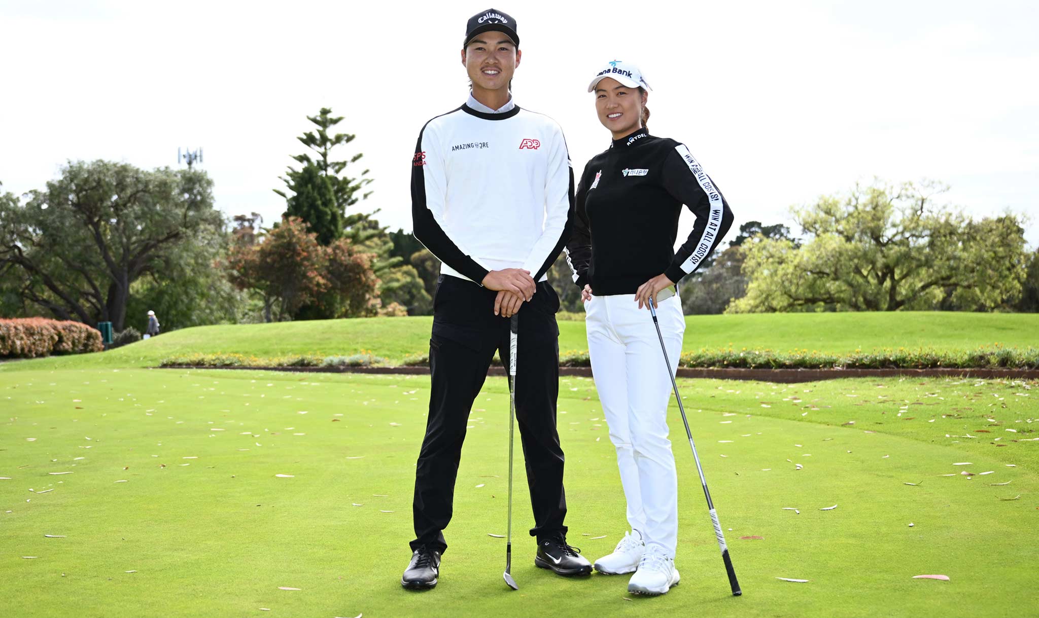 Golfers Min Woo and Minjee Lee pose on the green.